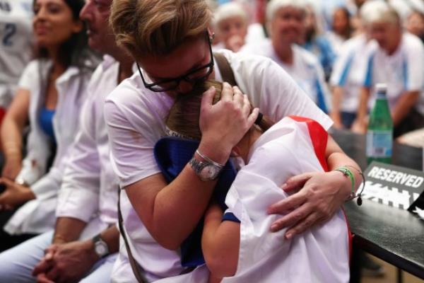 A young England fan is comforted at the end of the Women's World Cup final football match between Spain and England, at Boxpark Wembley in Lo<em></em>ndon on August 20, 2023. Spain beat England 1-0. (Photo by HENRY NICHOLLS / AFP) (Photo by HENRY NICHOLLS/AFP via Getty Images)