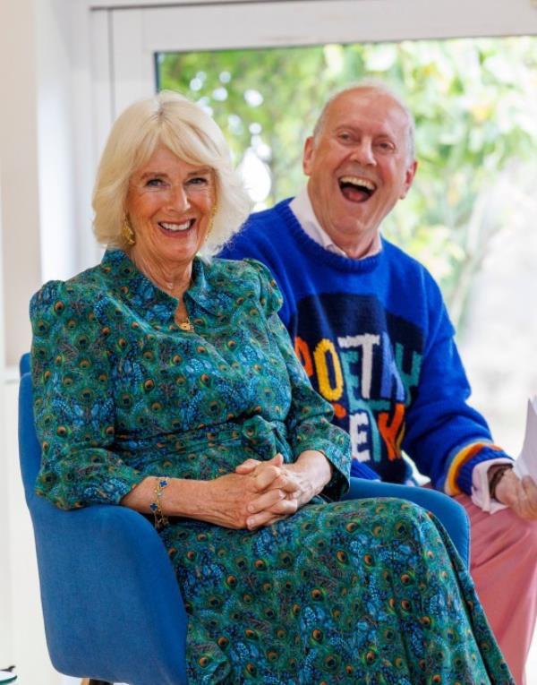 Queen Camilla and Gyles Brandreth smiling