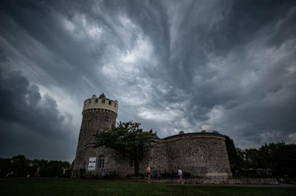 People pass Clifton Observatory, Bristol beneath an unusual low cloud formation and stormy skies as Thunderstorms hit parts of the UK amid a record-breaking September heatwave. Picture date: Sunday September 10, 2023. PA Photo. Photo credit should read: Ben Birchall/PA Wire