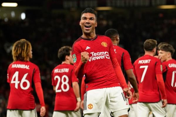 Manchester United's Casemiro celebrates after scoring his side's second goal during the English League Cup third round soccer match between Manchester United and Crystal Palace at Old Trafford stadium in Manchester, England, Tuesday, Sept. 26, 2023. (AP Photo/Dave Thompson)