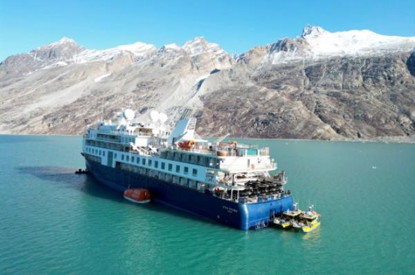 A view of the Ocean Explorer, a Bahamas-flagged Norwegian cruise ship with 206 passengers and crew, which has run aground in northwestern Greenland, on Tuesday, Sept. 12, 2023. The 104.4-meter (343-foot) long and 18-meter (60 foot) wide Ocean Explorer ran aground on Mo<em></em>nday in Alpefjord in the Northeast Greenland Natio<em></em>nal Park. It's the world?s largest and most northerly natio<em></em>nal park and is known for icebergs and the musk oxen that roam the coast. According to authorities no one on board was in danger and no damage has been reported. (SIRIUS/Joint Arctic Command via AP)