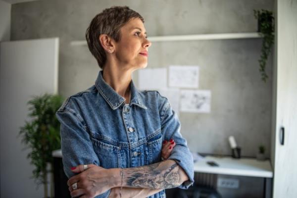 A mature woman with tattoos