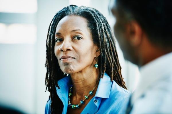 Mature businesswoman listening during meeting