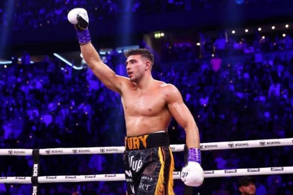 Tommy Fury celebrates after beating KSI