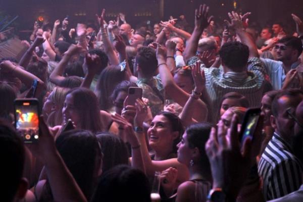 People party at the Pacha Ibiza nightclub in Ibiza, on June 16, 2022. - After being closed for two years because of the Covid-19 pandemic, the Mediterranean island's famous mega-clubs have reopened their doors, drawing thro<em></em>ngs of partygoers. The pandemic affected all sectors but the leisure sector -- which employs over 3,000 people directly and indirectly -- was the last to fully after virus restrictions were lifted. (Photo by LLUIS GENE / AFP) (Photo by LLUIS GENE/AFP via Getty Images)