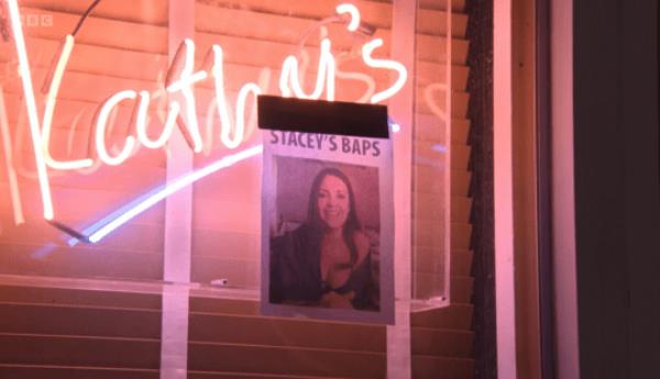 Poster of Stacey in her underwear on the window of Kathy's café in EastEnders