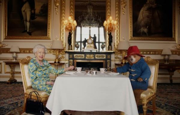 Undated image of Britain's Queen Elizabeth and Paddington Bear havin<em></em>g cream tea at Buckingham Palace taken from a film that was shown at BBC's Platinum Party at the Palace. Released June 4, 2022. Buckingham Palace/Studio Canal/BBC Studios/Heyday Films/PA Wire/Handout via REUTERS NO RESALES. NO ARCHIVES. MANDATORY CREDIT. NO COMMERCIAL SALES. MUST NOT BE ALTERED. NO NEW USES AFTER JUNE 30, 2022. NOTE TO EDITORS: This handout photo may o<em></em>nly be used in for editorial reporting purposes for the co<em></em>ntemporaneous illustration of events, things or the people in the image or facts mentio<em></em>ned in the caption. Reuse of the picture may require further permission from the copyright holder. EDITORIAL USE ONLY. The copyright for the photograph vests with Buckingham Palace/ Studio Canal / BBC Studios. Publications are asked to credit Buckingham Palace/ Studio Canal / BBC Studios / Heyday Films. The photograph shall not be used without permission from Royal Communications. There shall be no commercial use whatsoever of the photograph (including any use in merchandising, advertising or any other non-editorial use). The photograph must not be digitally enhanced, manipulated or modified in any manner or form when published. The photograph will be free for press usage until 30th June 2022. It must not be used after this date without prior, written permission from Royal Communications, and no further licensing can be made.