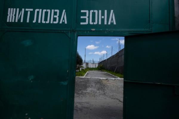 LVIV REGION, UKRAINE - AUGUST 3: The gate that reads Residential Area is seen leading into the POW Priso<em></em>ner of war detention camp in the Lviv region, western Ukraine on August 3, 2023. Hundreds of captured Russian POWs including cons<em></em>cripts, mercenaries, Wagner militia and Storm-Z Russian priso<em></em>ners are being held in up to 50 sites around Ukraine. Storm-Z is a series of penal military units established by Russia since April 2023. (Photo by Paula Bro<em></em>nstein /Getty Images