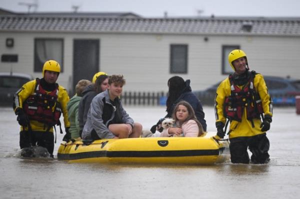 BURTON BRADSTOCK, DORSET - NOVEMBER 02: People are rescued from their holiday chalets by fire and rescue at Freshwater Beach Holiday Park, on November 02, 2023 in Burton Bradstock, Dorset. Storm Ciaran swept across the southwest and south of England overnight posing a formidable threat in certain areas such as Jersey, wher<em></em>e winds exceeded 100 mph overnight. This, along with the already-soaked ground from Storm Babet, increases the risk of flooding in already vulnerable areas. (Photo by Finnbarr Webster/Getty Images)