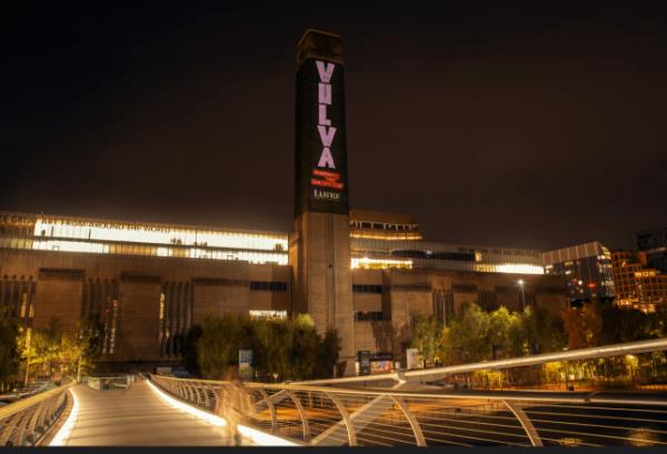 An image of the Tate Modern with the word 'vulva' projected o<em></em>nto the chimney 