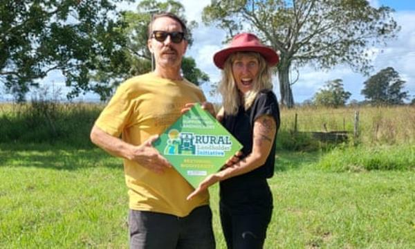 Lissie Turner and her husband pose in the riverside property they are regenerating near Lismore.