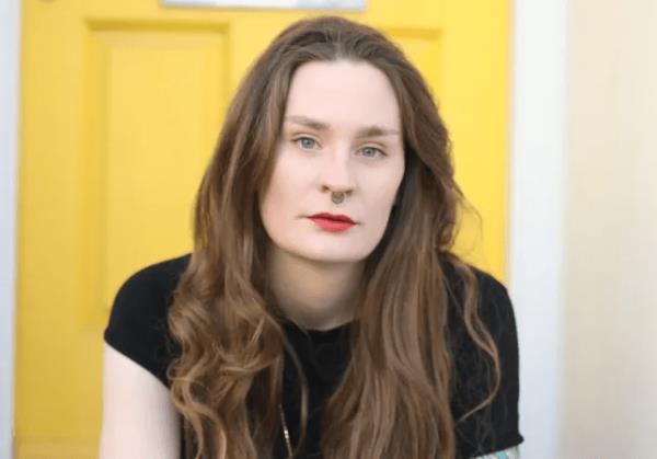 Ugla sitting in front of a yellow door